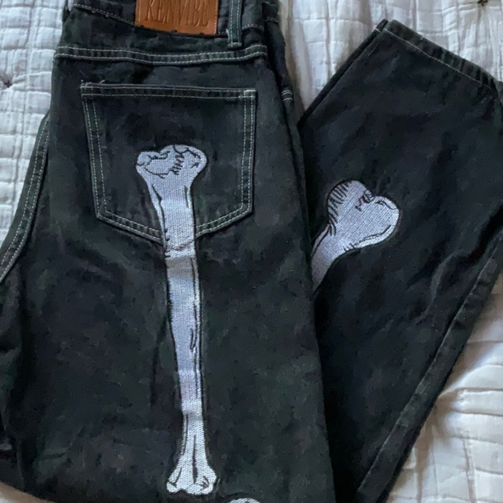 Black baggy pants with bone embroidery.